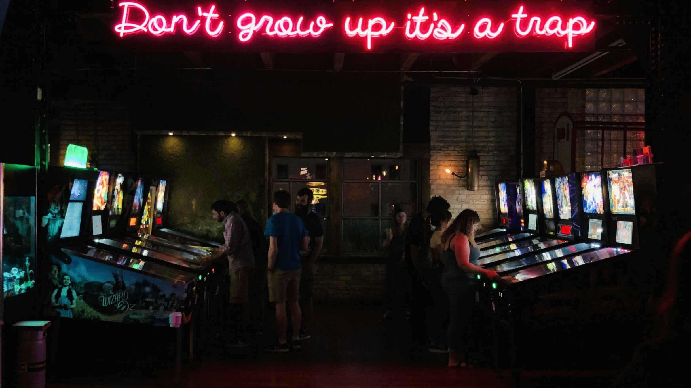 Nighttime arcade entrance with glowing sign